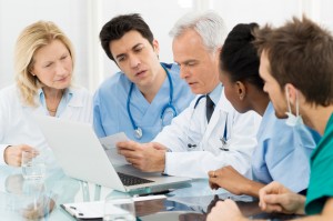 Team Of Doctors Examining Reports